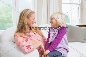 Happy mother and daughter on the couch