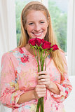 Happy woman holding red roses