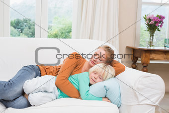Happy mother and daughter napping on the couch