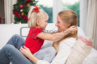 Cute daughter and mother celebrating christmas
