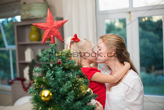 Cute daughter and mother celebrating christmas