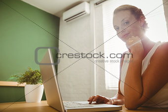 Pretty businesswoman using her laptop