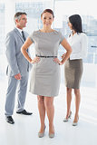 Businesswoman standing beside other employees