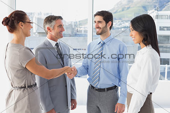 Two fellow employees shaking hands
