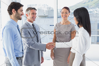 Two fellow employees shaking hands