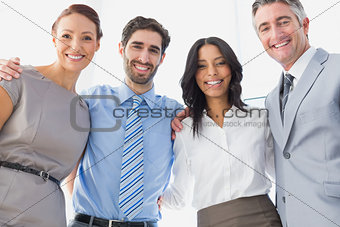 Workers smiling while standing together