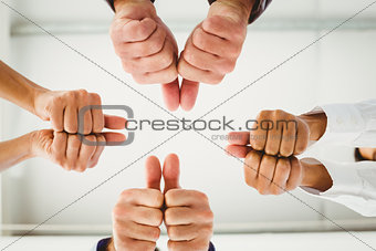 Multiple hands giving thumbs up