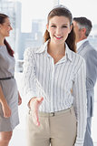 Smiling business woman offering handshake