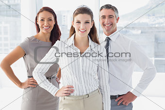 Smiling businesswoman with hand on hip