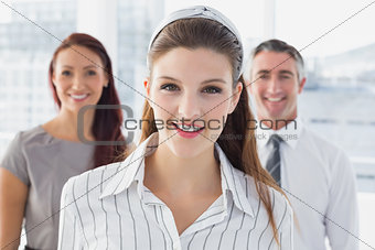 Smiling businesswoman and her colleagues