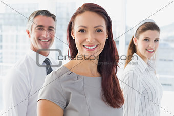 Smiling businesswoman and her co-workers