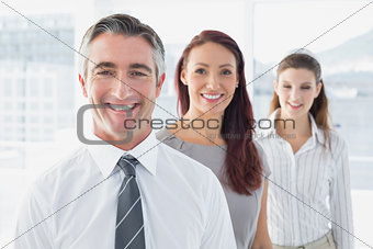 Smiling businessman and his co-workers