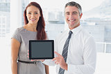 Business people holding up tablet
