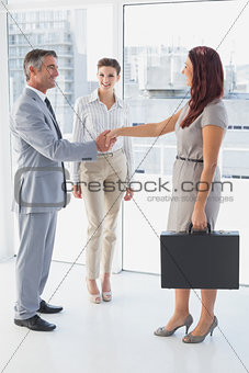 Businessman shaking co-workers hand