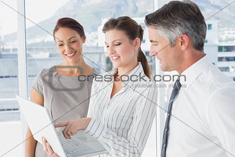 Businesswoman using laptop at work