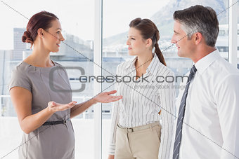 Businesswoman talking with her co-workers