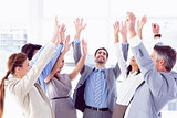 Business team raising their hands