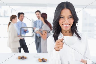 Smiling businesswoman with a drink