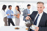 Businessman pouring himself some coffee