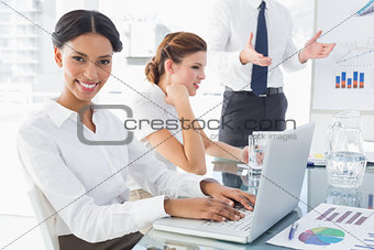 Businesswoman typing at a presentation