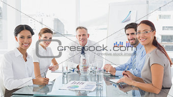 Business team looking at camera