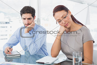 Businesswoman and her colleague reading