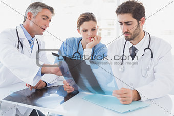 Doctors sitting together with x-rays