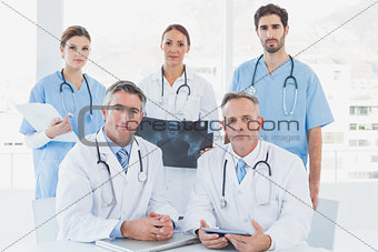 Doctors looking serious at camera