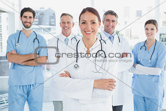 Smiling doctor with fellow doctors