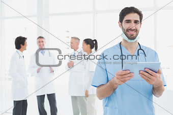 Smiling doctor with a tablet