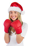 Festive blonde punching with boxing gloves