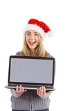 Festive blonde holding a laptop
