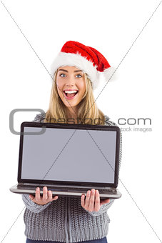 Festive blonde holding a laptop