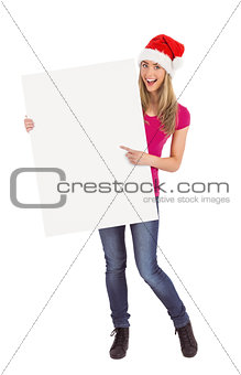 Festive blonde holding large poster