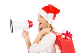 Festive blonde holding megaphone and bags