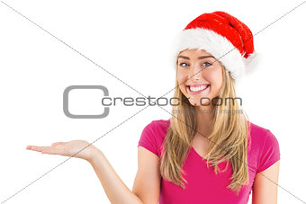 Festive blonde presenting with hand