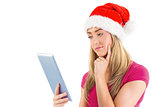 Festive blonde looking at tablet pc