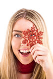 Happy blonde holding red snowflake
