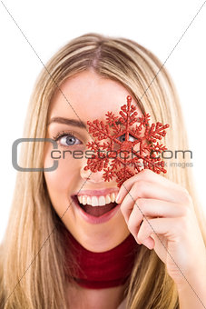Happy blonde holding red snowflake