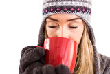 Happy blonde in winter clothes holding mug