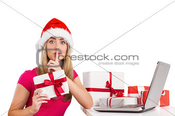 Festive blonde shopping online with laptop