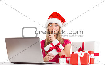 Festive blonde shopping online with laptop