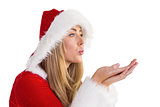 Pretty santa girl blowing over hands