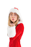 Pretty santa girl blowing over hand