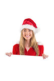 Pretty santa girl smiling at camera with poster