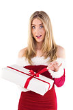 Pretty santa girl opening gift