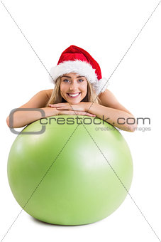 Festive fit blonde posing with exercise ball