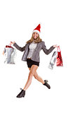 Festive blonde jumping with shopping bags
