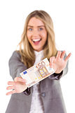 Stylish blonde showing fifty euro note