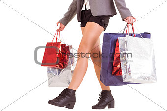 Lower half of woman with shopping bags